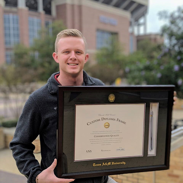 male-holding-diploma-frame